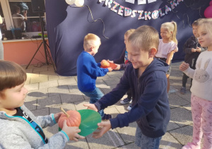 Dzieci z grupy "Biedronek" przekazują sobie dynie podczas konkurencji sprawnościowej.