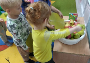 Jagoda, Emil i Józio podczas wrzucania jabłka do miski.