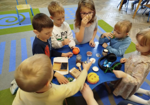 Dzieci samodzielnie eksperymentują z różnymi zmysłami za pomocą różnych przedmiotów: słuchawki, pędzelki, świece, gąbka, opaska na oczy.