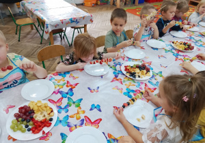 12.Grupa dzieci w trakcie konsumowania szaszłyków.