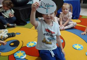 Nikodem prezentuje obrazek z samolotem.