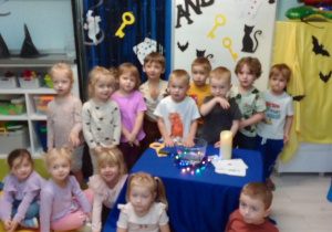 Wspólne zdjęcie "Pszczółek" na tle dekoracji andrzejkowej.