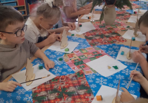 Dzieci podczas malowania choinek.