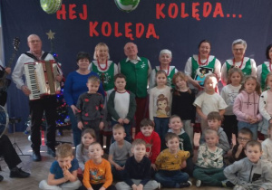 Dzieci oraz wychowawcy grupy "Słoneczka" pozują do wspólnego zdjęcia z członkami Zespołu "Leszczynianki".