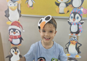 16. Ignacy pozuje do zdjęcia w pingwinkowej foto-ramce.