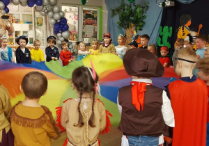 Dzieci uczestniczą w zabawach z chustą animacyjną.