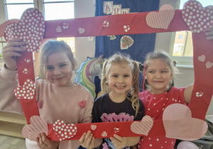 Weronika, Ala i Klara pozują do zdjęcia w foto-ramce.